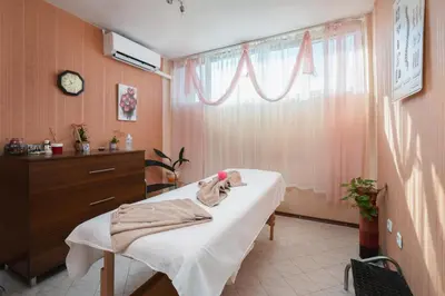 a hospital room with a bed and a window at Balneocomplex Kamena in Velingrad