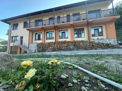 a house with a bunch of flowers in front of it at Стаи за гости Куцеви in Devin