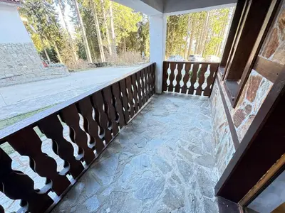 a balcony with a fence and two windows at 