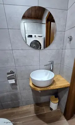 a bathroom with a sink and a washing machine at Studio Todorka in Bansko