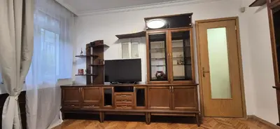 a room with a entertainment center with a flat screen tv at Venelin Apartment in Sofia