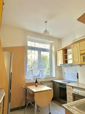 a small kitchen with a table and a window at Venelin Apartment in Sofia