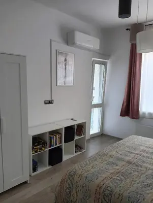 a white bedroom with a bed and a window at My place in Sofia - Top center - 2 bedrooms - Self check-in in Sofia