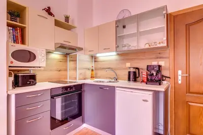 a small kitchen with white cabinets and appliances at Relaxing Mountain Getaway in Cozy Studio by Flat Mаnager in Pamporovo
