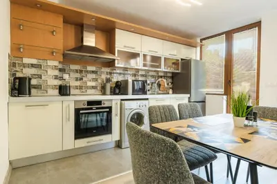 a kitchen with a table and a dining room at Sweet Home 2 in Sandanski