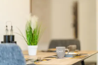 a wooden table with a coffee cup on it at Sweet Home 2 in Sandanski