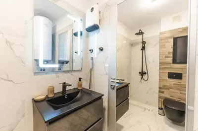 a bathroom with a sink and a mirror at Sweet Home 2 in Sandanski