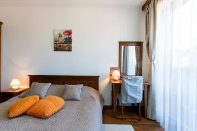 a bedroom with a bed with two pillows on it at Pirin Golf & Country Club Apartment in Bansko