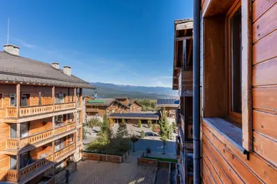 a view from the balcony of a resort building at Pirin Golf & Country Club Apartment in Bansko