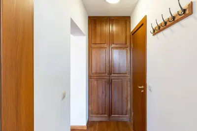a hallway with a wooden door in a room at Pirin Golf & Country Club Apartment in Bansko
