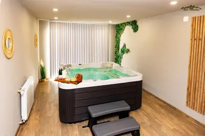 a bathroom with a soaking tub with two stools at Villa Malevitsa Вила Малевица in Relyovo