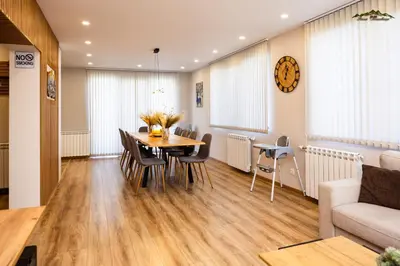 a living room with a table and chairs and a couch at Villa Malevitsa Вила Малевица in Relyovo