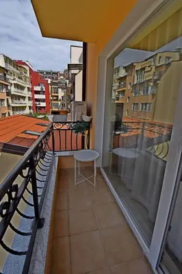 a balcony with a table and a chair on a building at INB Banishora spot 9 in Sofia