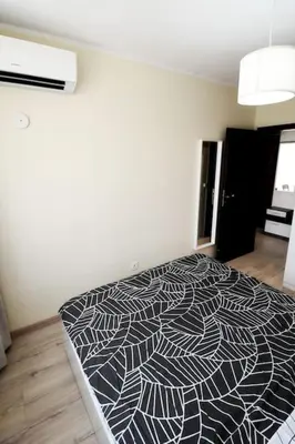 a bedroom with a black and white bed in a room at INB Banishora spot 9 in Sofia