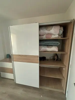 a closet with a white door and wooden shelves at Turquoise City Exotic Bliss in Sofia