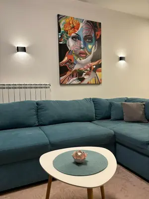a blue couch with a coffee table in a living room at Turquoise City Exotic Bliss in Sofia