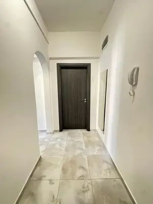 a hallway with a black door and a tiled floor at Lions Bridge C-E-N-T-R-A-L in Sofia