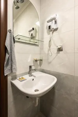 a bathroom with a white sink and a mirror at Комплекс Стадиона in Velingrad