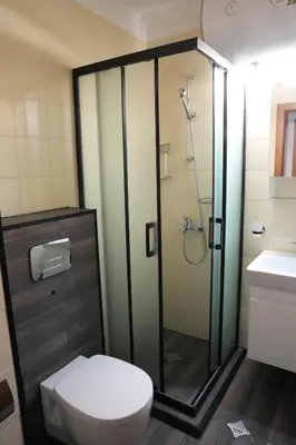 a bathroom with a shower and a toilet and a sink at Two-bedroom Apartment Paskalina, near the Ski lift in Bansko