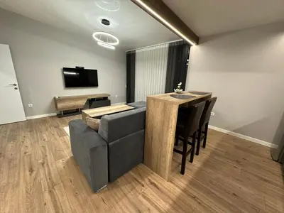 a living room with a couch and a table at Vimar Apartments in Panagyurishte