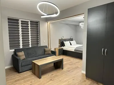 a living room with a couch and a bed at Vimar Apartments in Panagyurishte