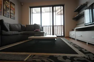 a living room with a couch and a coffee table at Penthouse 2 Bedroom Apartment w fireplace in Bansko