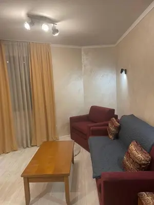 a living room with a couch and a table at English Apartments in Bansko