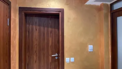 a wooden door in the corner of a room at English Apartments in Bansko