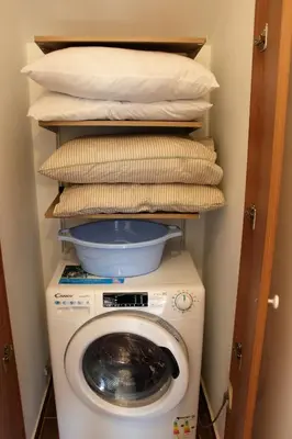 a washing machine with pillows on top of it at One bedroom ap 602 IN RILA PARK for 6 people in Borovets