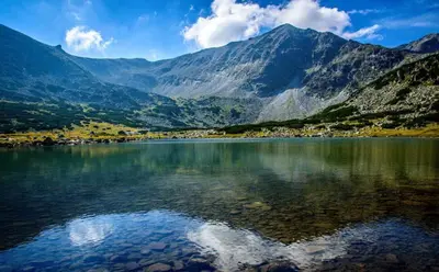 a large body of water with mountains in the background at One bedroom ap 602 IN RILA PARK for 6 people in Borovets