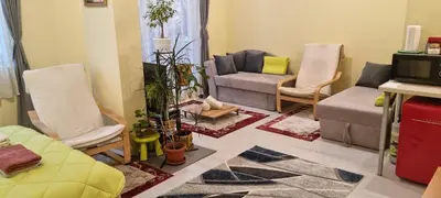 a living room with two chairs and a couch at Peaceful studio in the city center, close to subway, Medical University in Sofia