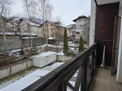 a balcony with snow on the ground and buildings at Apartment Niko in Bansko