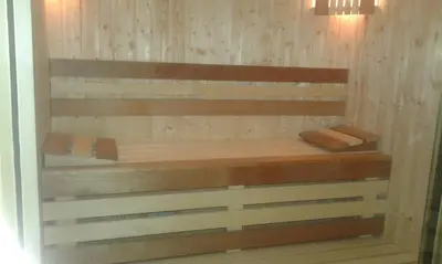 a shelf in a room with wooden walls at Family Hotel Relax in Strelcha
