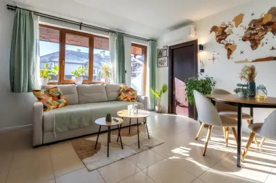 a living room with a couch and a table at The Snowmad Nest - Valentina Heights, 8 min from the gondola in Bansko