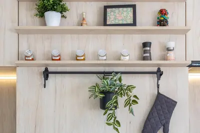 a shelf with jars and a plant on a wall at The Snowmad Nest - Valentina Heights, 8 min from the gondola in Bansko