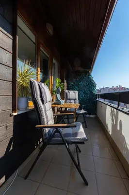 a patio with two chairs and a table on a balcony at The Snowmad Nest - Valentina Heights, 8 min from the gondola in Bansko