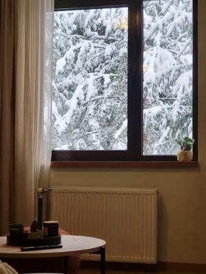 a view of a snow covered mountain through a window at Exquisite Euphoria apartment for 4 Guests in Borovets Ski Resort in Borovets