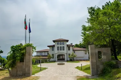 a building with two flags in front of it at Вила Белисима, Villa Bellissima in Kara Agach