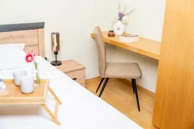 a bedroom with a desk and a bed with a chair at Large One Bedroom Flat - Mountain Bliss in Borovets