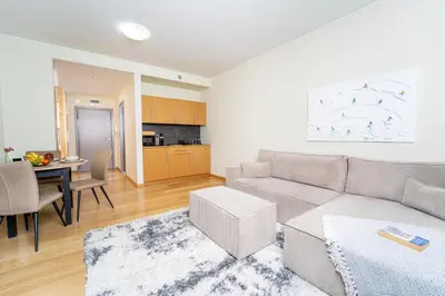 a living room with a couch and a table at Large One Bedroom Flat - Mountain Bliss in Borovets