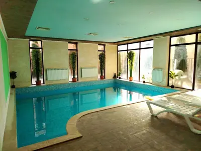 a large swimming pool in a house with a poolvisor at Хотел Релакс in Velingrad