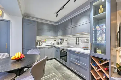 a kitchen with blue cabinets and a table and chairs at A new sense of home in Sofia