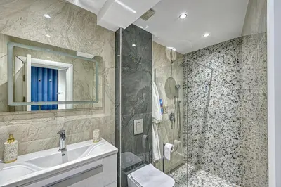 a bathroom with a sink and a shower at A new sense of home in Sofia
