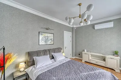 a bedroom with a bed and a chandelier at A new sense of home in Sofia