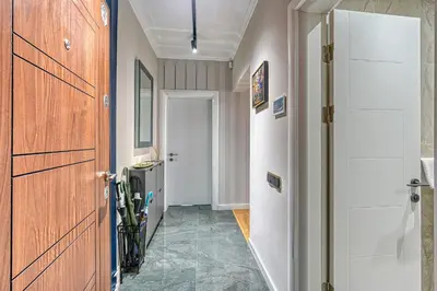 a hallway with a wooden door and a hallway with a hallway at A new sense of home in Sofia