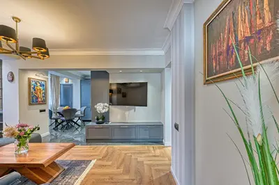 a living room with a table and a dining room at A new sense of home in Sofia