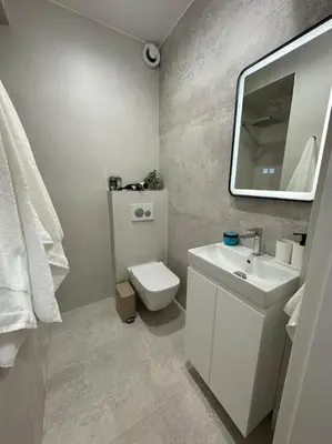 a bathroom with a toilet and a sink and a mirror at The Urban Pearl in the Heart of Sofia next to National Palace of Culture in Sofia