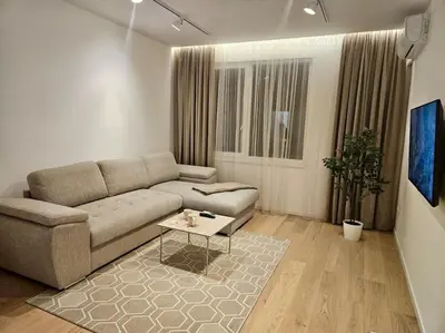 a living room with a couch and a coffee table at The Urban Pearl in the Heart of Sofia next to National Palace of Culture in Sofia