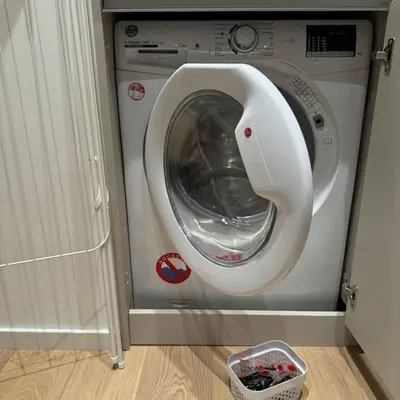 a washing machine in a room with a basket at The Urban Pearl in the Heart of Sofia next to National Palace of Culture in Sofia