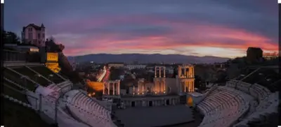 a view of a city at night with a sunset at Apartamento Violette OLD Town Plovdiv in Plovdiv